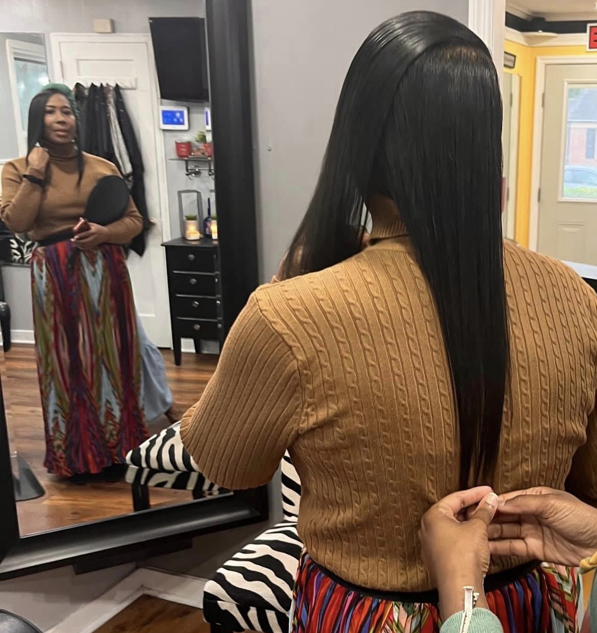 Mary at the mirror getting styled — a glimpse of her signature elegance