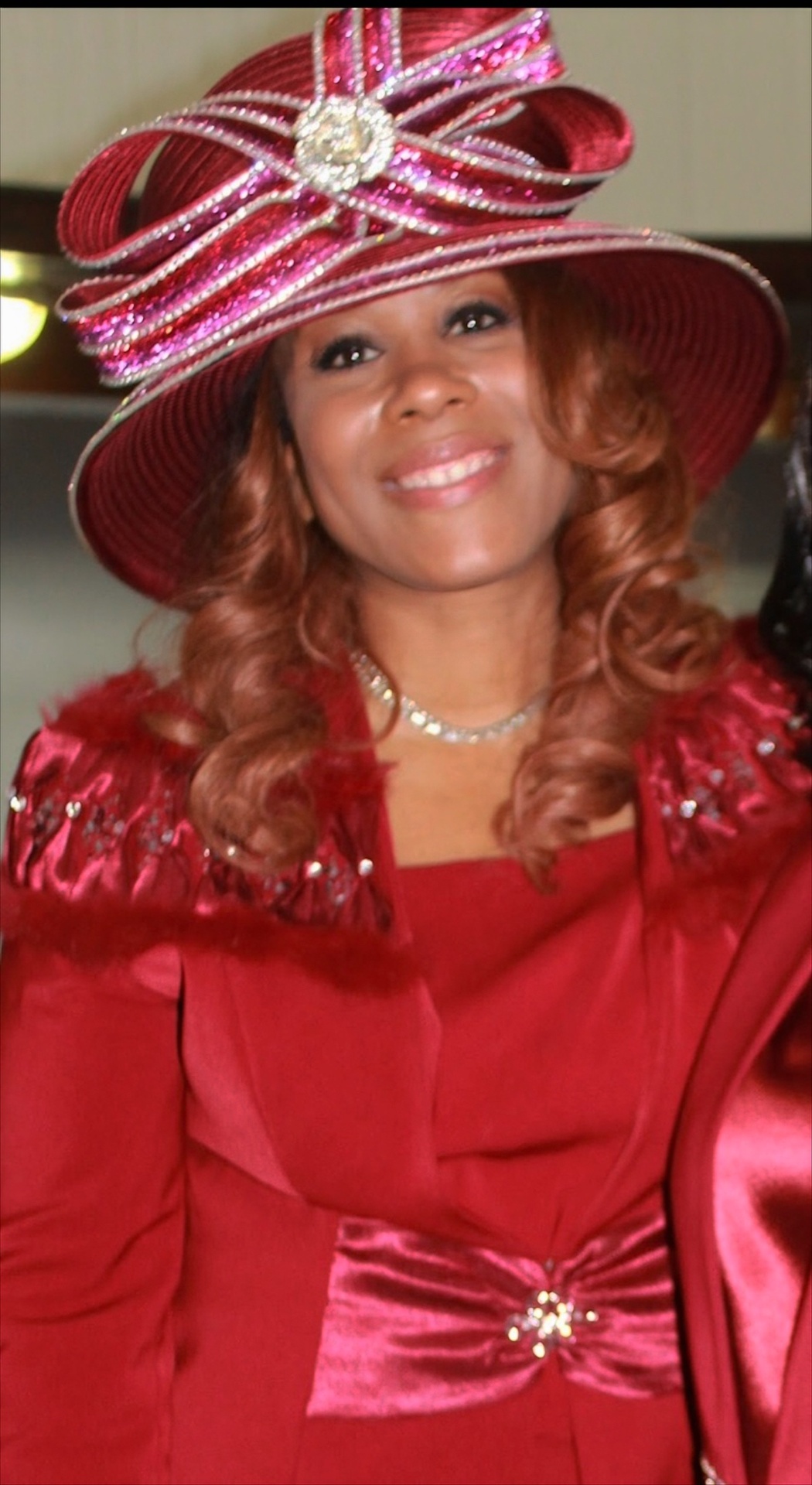 Mary Kingcannon in a red rhinestone hat and matching suit